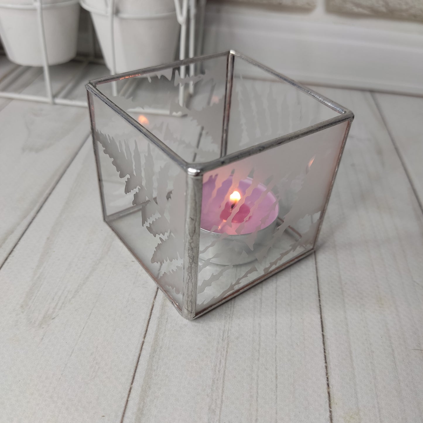 Holiday lights, geometric candles, glass holiday decor